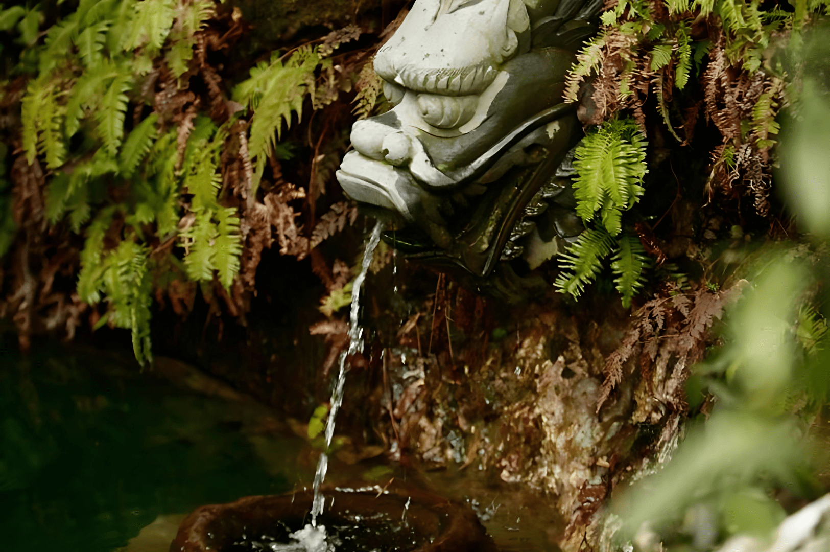 Ornate dragon-head fountain nestled in lush greenery near Hangzhou’s Longjing Dragon Well water, symbolizing the rich heritage and purity of authentic Chinese Longjing tea.