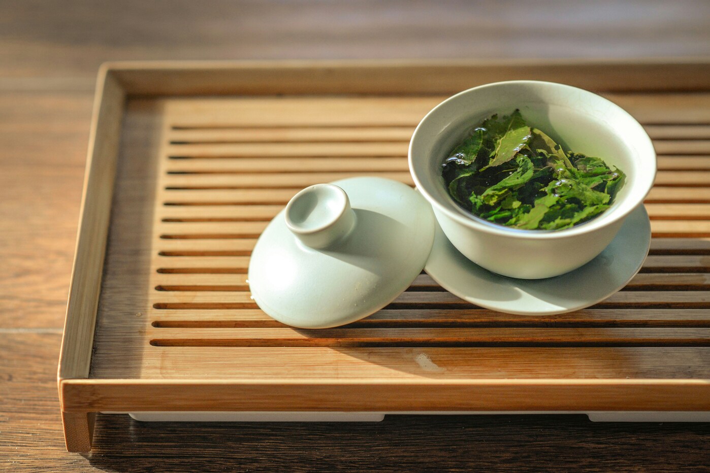 Japanese Green Tea : A pot of freshly brewed green tea releasing gentle steam in a traditional Japanese teahouse.