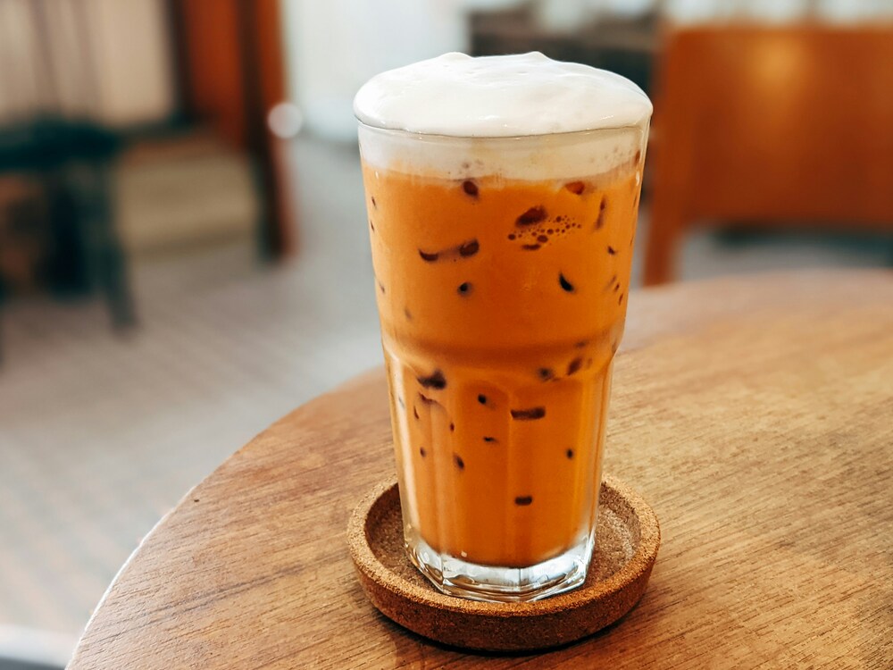 Thai Oolong Tea : Chilled Thai tea with a rich amber hue topped with silky milk.